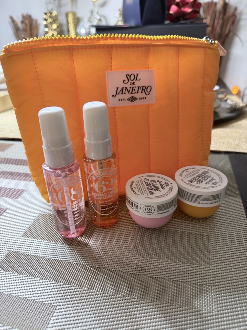 Sol de Janeiro Bright Orange Quilted Pouch with Mini Serums & Creams